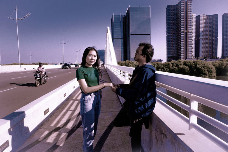 Man and woman on bridge holding each other