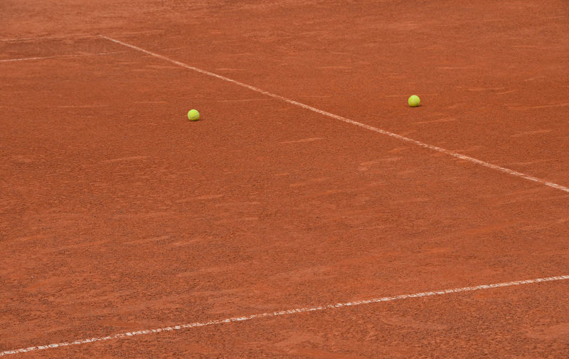 Yellow balls on tennis court