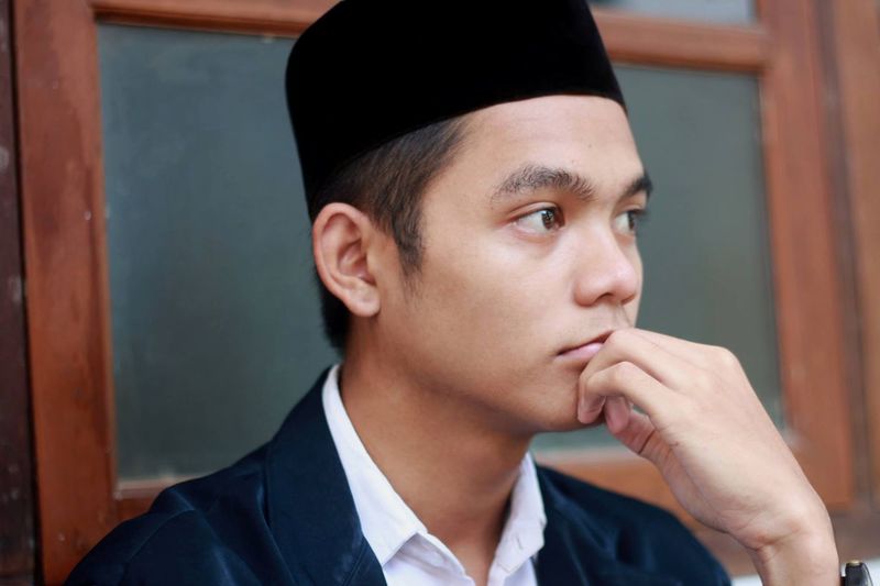 Close-up portrait of asian muslim boy looking away