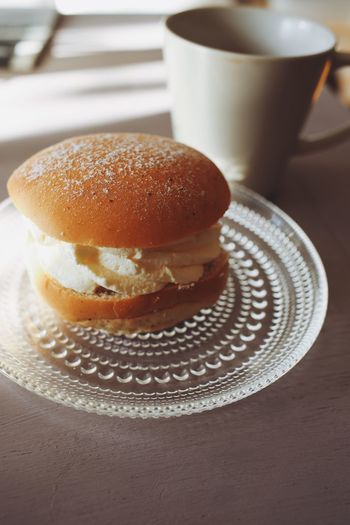 Close-up of coffee served on table with a bun called semla 