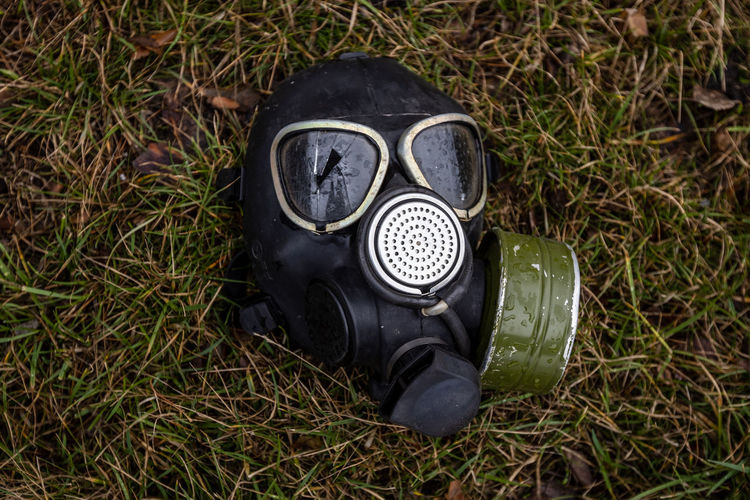 Gas mask on the ground with broken glass near the right eye. shot eye. irpin, bucha, gostomel.