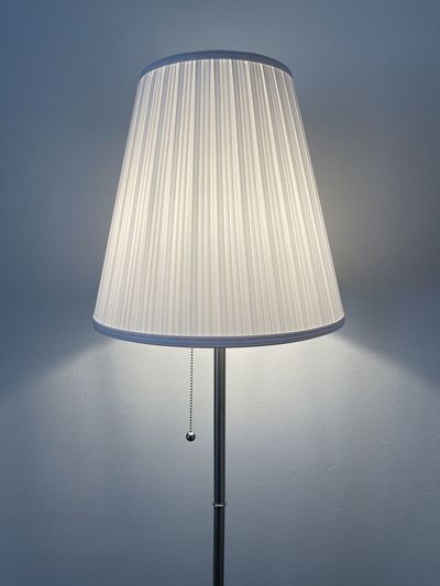 White classic lamp with shining light on the wall
