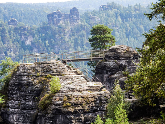Scenic view of bridge over rock mountains