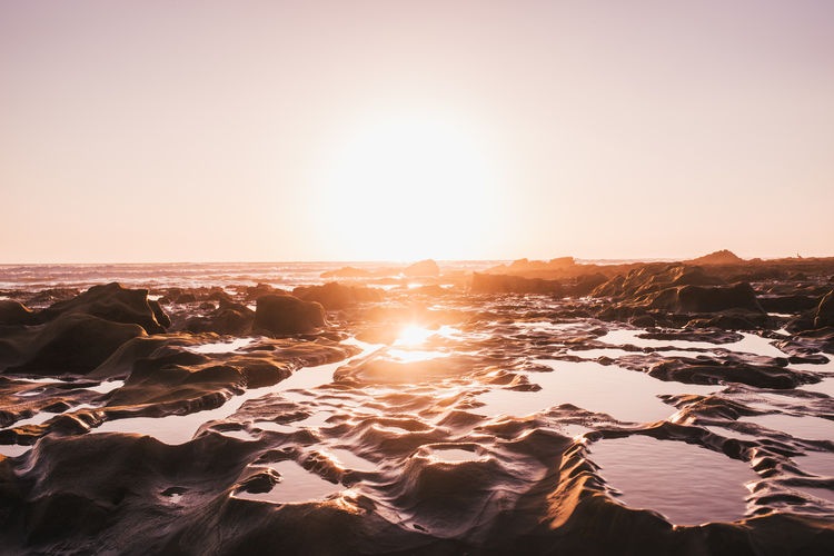 Scenic view of sea against clear sky during sunset