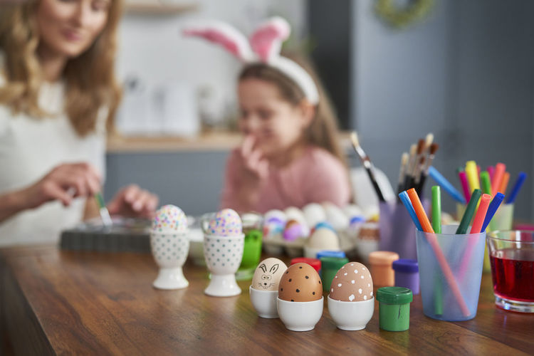Decorated easter eggs on table at home