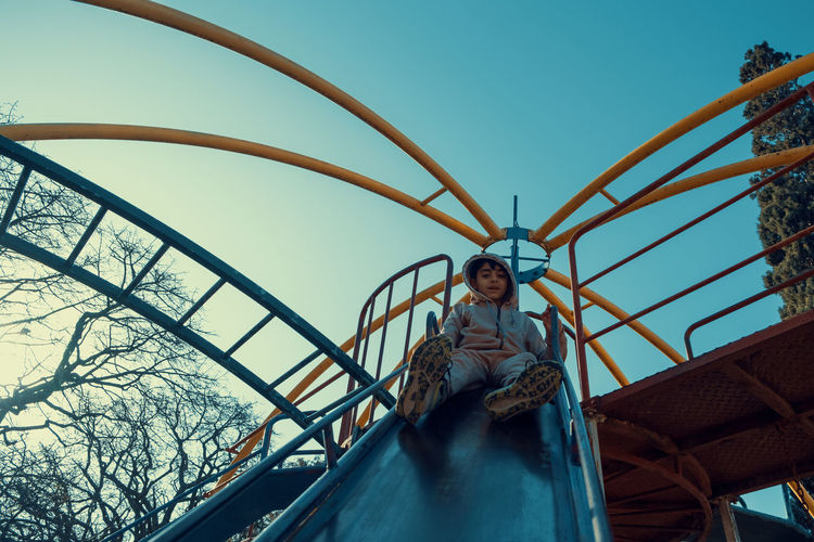 Portrait of boy on slide at playground