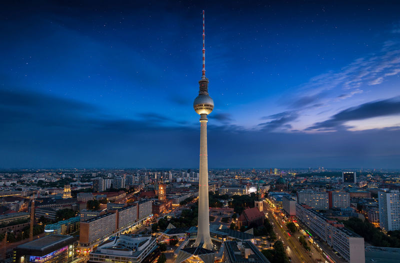 Fernsehturm amidst illuminated city at night