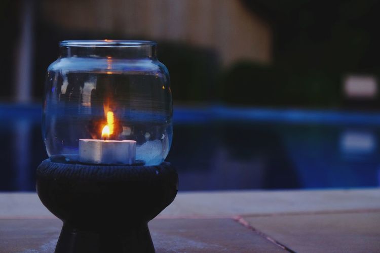 Close-up of illuminated candle against blurred background