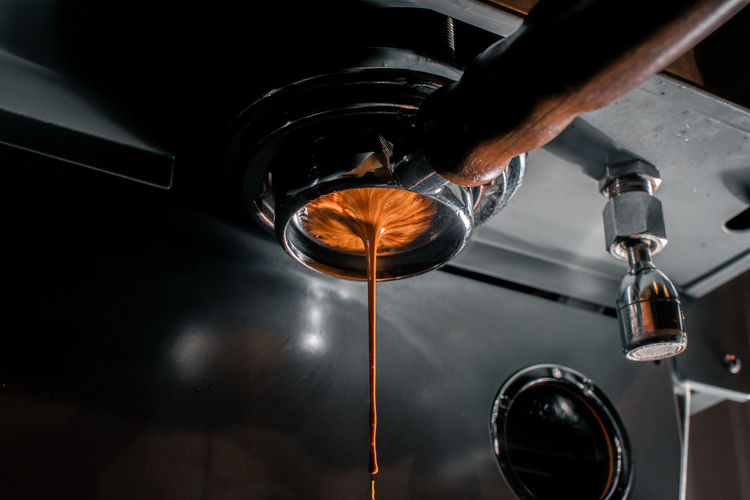 Close-up of espresso shot being prepared in a coffee bar. pulling a shot
