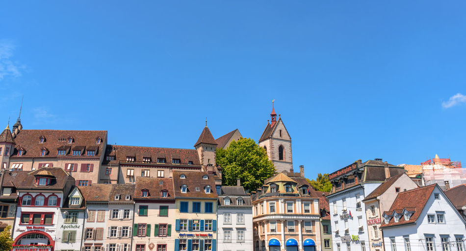 Low angle view of buildings against blue sky at barfusserplatz