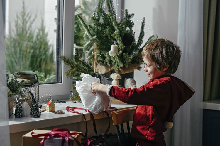 Side view of mother and daughter sitting at home