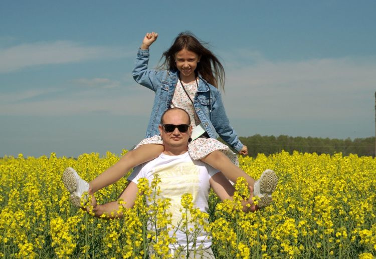 Cheerful little girl on dad's shoulders