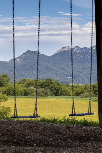 Outdoor swing in front of mountains, scenic view 