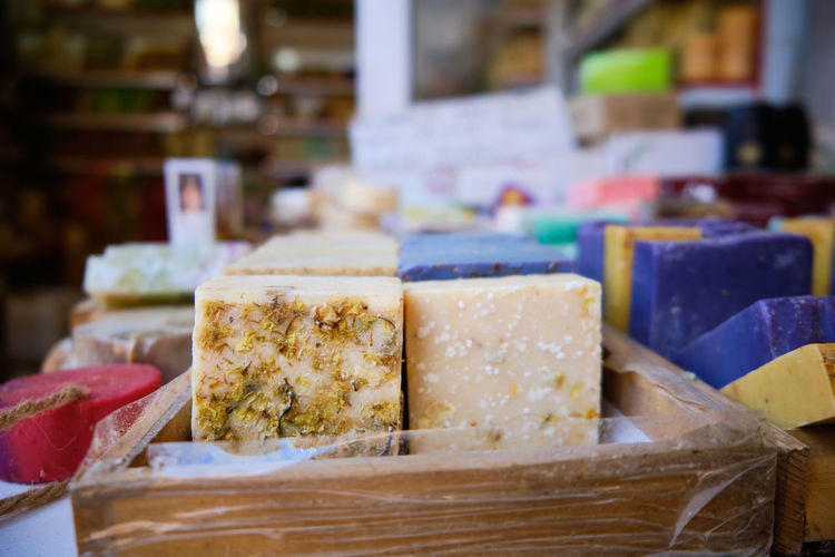 Craft multi-colored natural organic soap bars at shop shelf. traditional soap manufacture