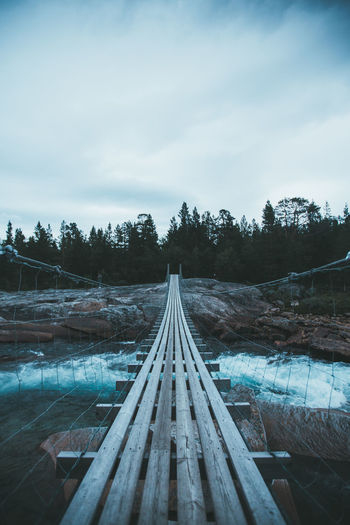 Hanging bridge crossing a small but wild creek somewhere in norway