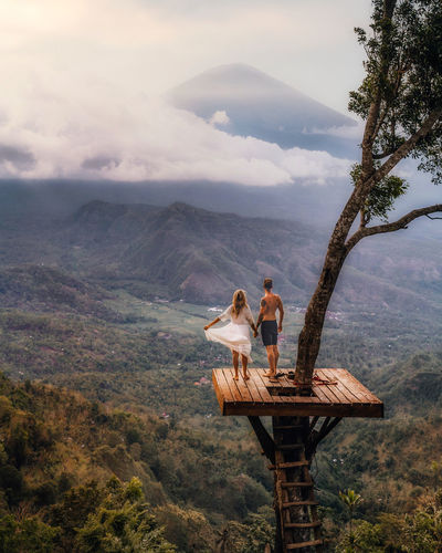 High angle view of couple standing on tree house