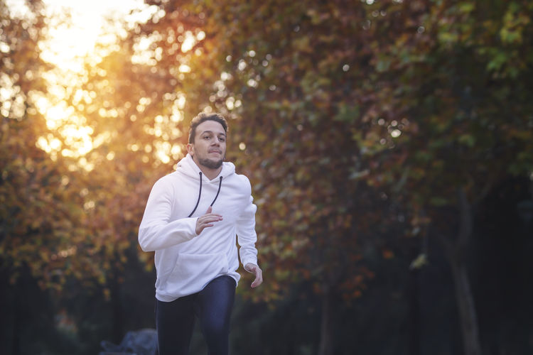 Young man running in a park in the afternoon. healthy lifestyle concept