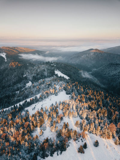 Moody aerial drone idyllic winter landscape at sunrise. wiew from the top of the mountains.