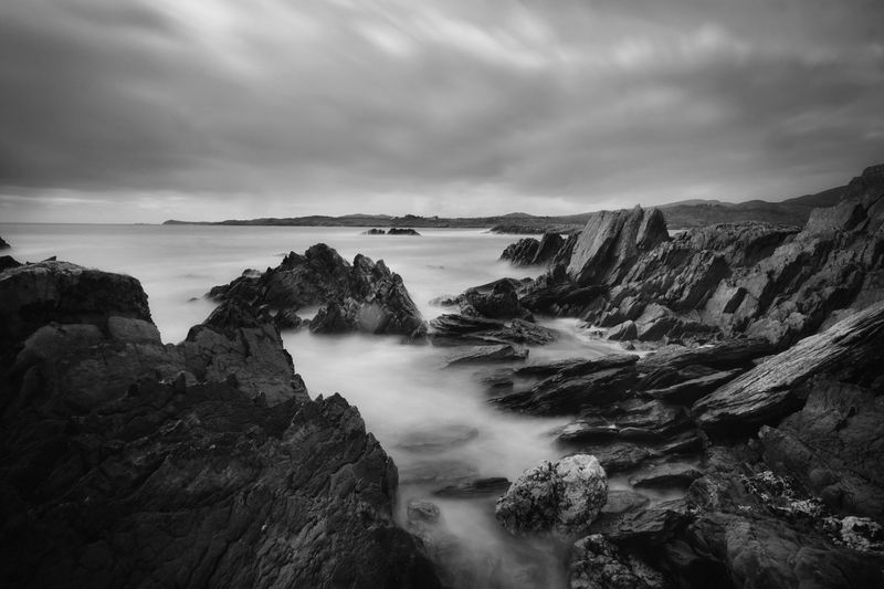 Scenic view of rocks in mountains against sky