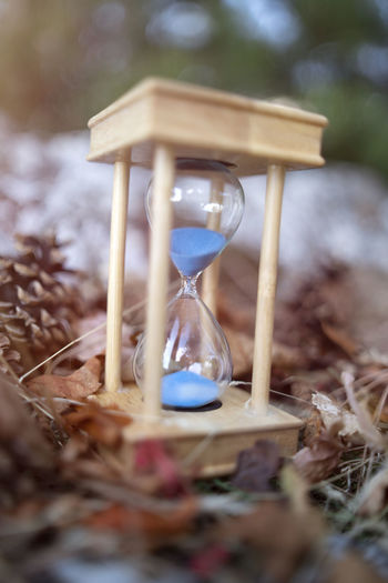 Close-up of clock falling on glass at field