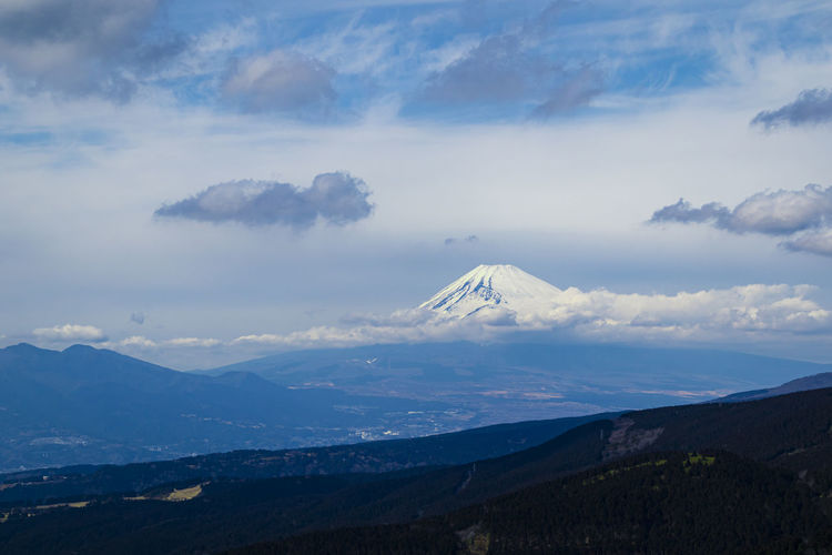 Aerial view of the mount fuji with layered hills in the foreground. landscape orientation.