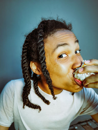 Close-up portrait of young woman eating food