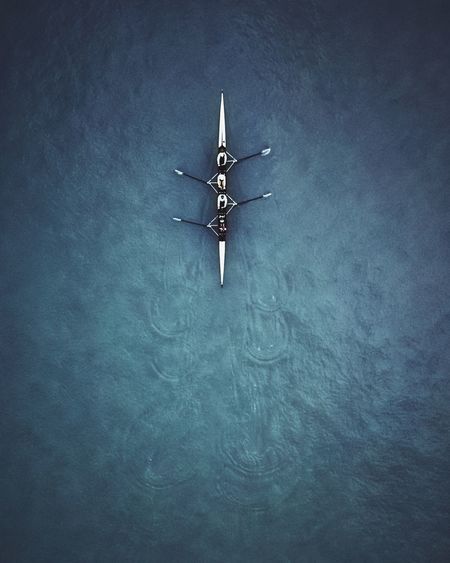 Aerial view of people rowing boat at sea
