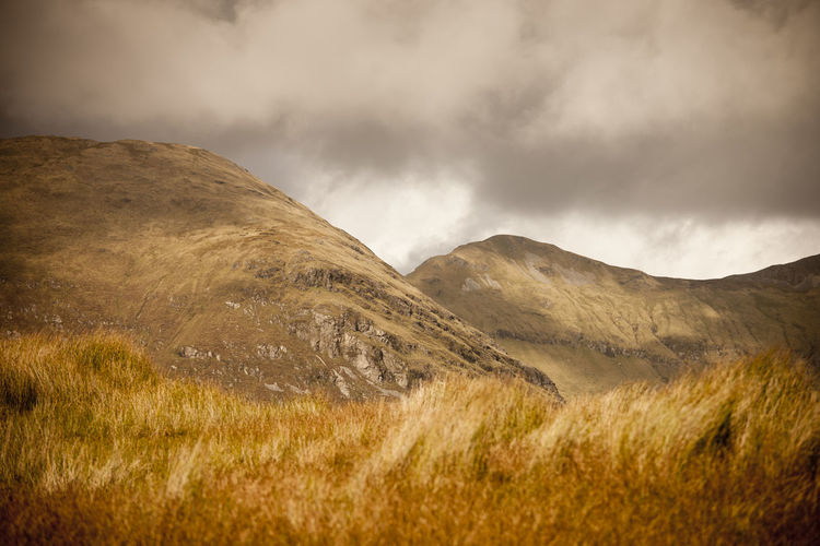 Scenic view of field against scenic view of connemara mountains against skysky