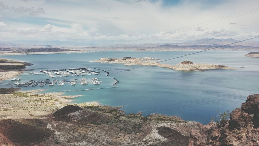 Scenic view of harbor in lake mead against cloudy sky