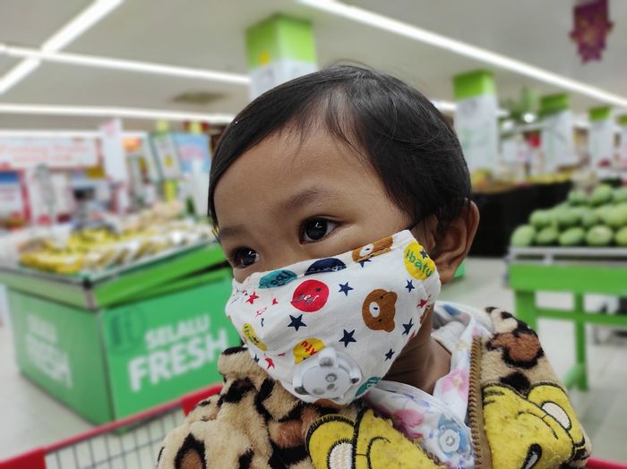 Portrait of cute baby in the supermarket