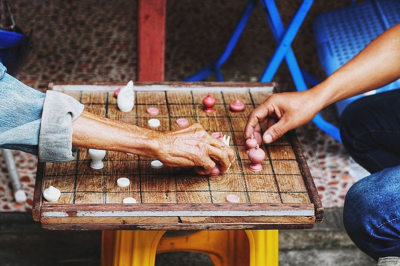 Close-up of hands playing board game