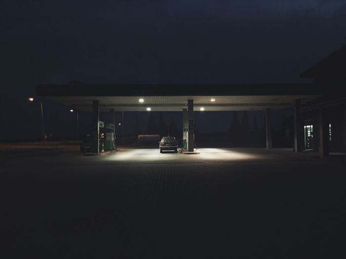 Cat in illuminated gas station at night