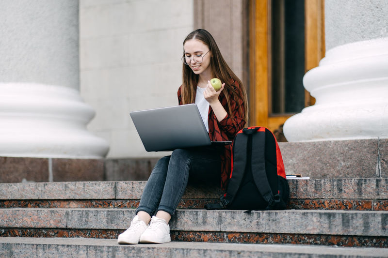 Student loan, student finance for undergraduates. outdoor portrait of student girl