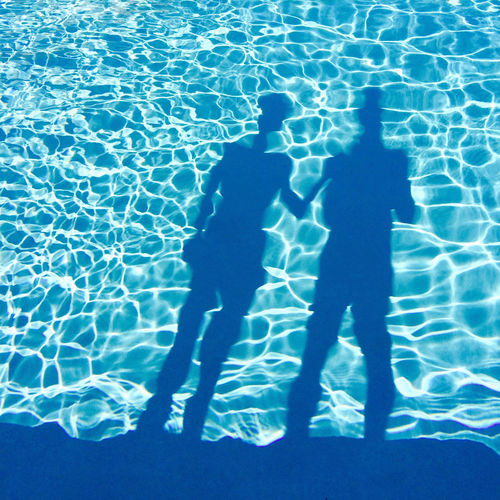 Shadow of people on swimming pool
