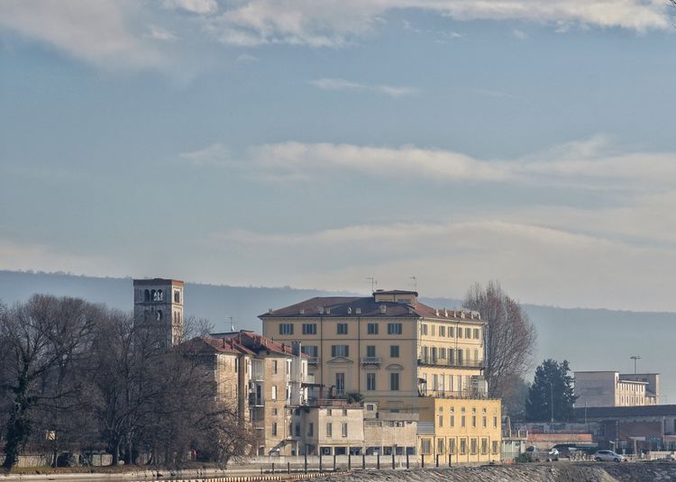 A glimpse of a view of the town of ivrea,on the banks of the river,with a slightly cloudy sky, italy 