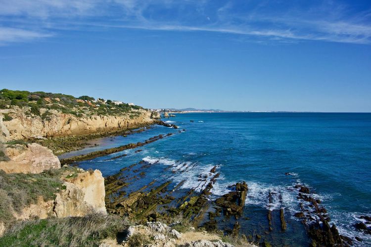 Scenic view of sea against blue sky