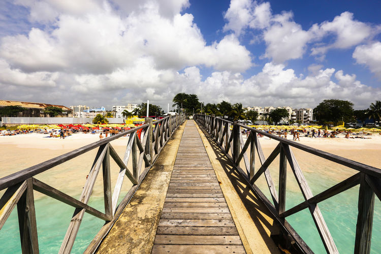 Pier over river against sky