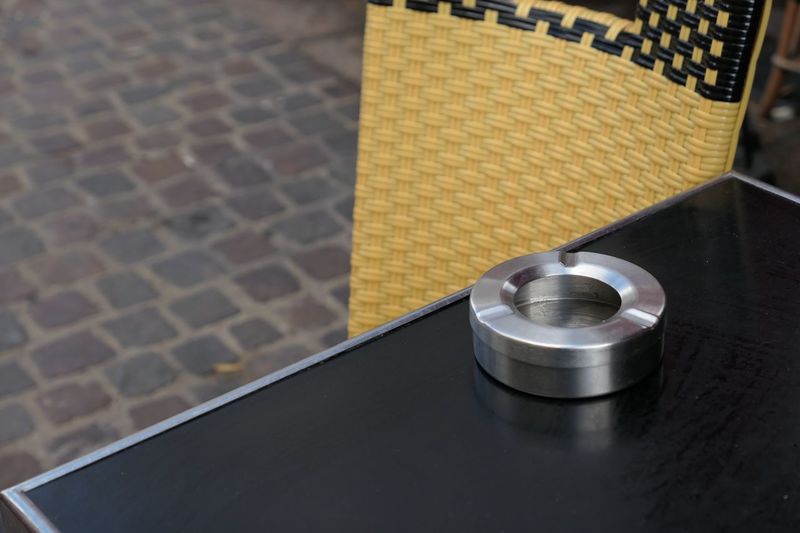 Close-up of ashtray on table outdoors