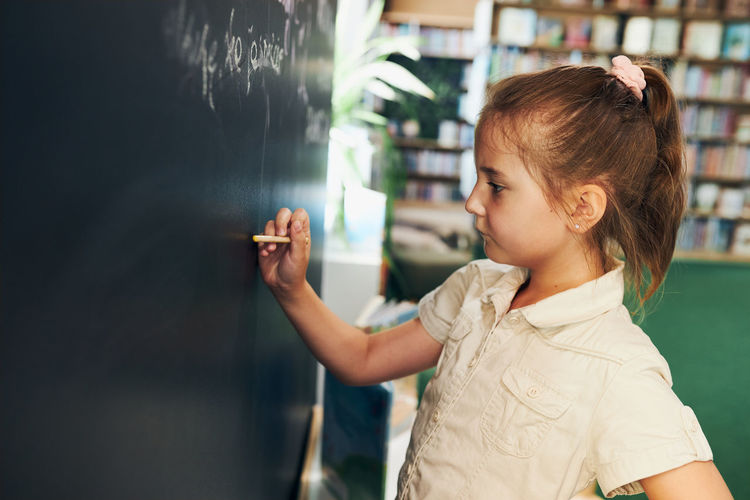 Student writing on blackboard. smart student put solve on chalkboard. back to school. solution