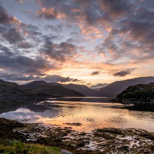 Scenic view of lake against sky during sunset
