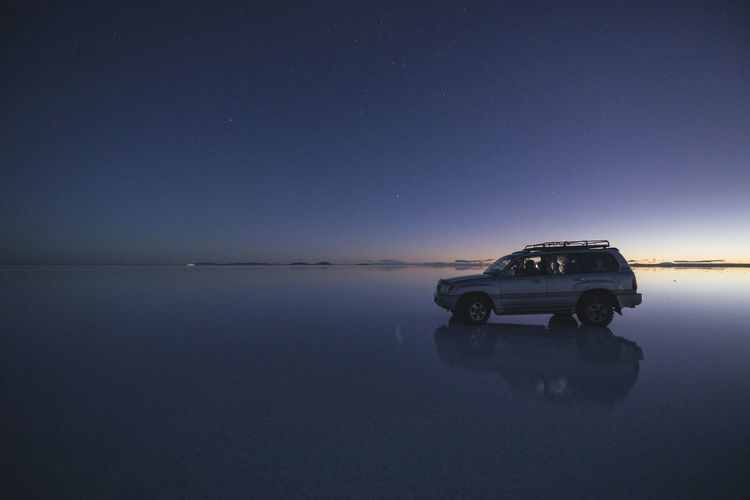 Car over water under the stars