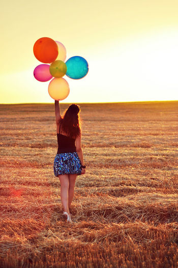 Woman standing on grassy field