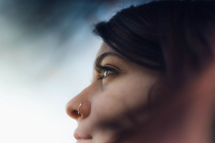 Close-up portrait of woman against sky