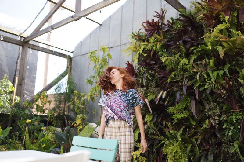 Woman standing by plants