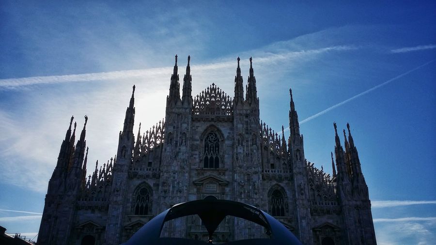 Low angle view of duomo di milano against sky