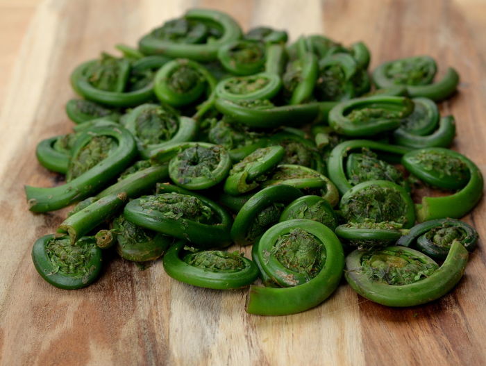 Close-up of fiddleheads on table at home