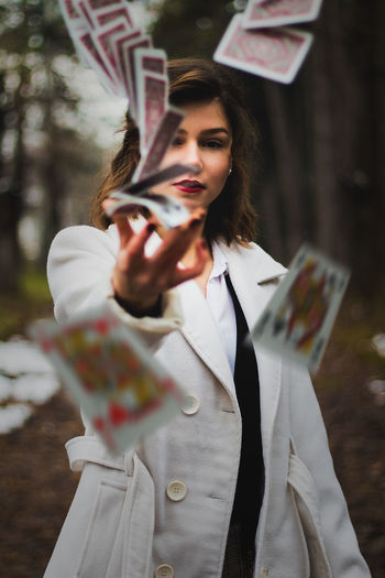 Portrait of woman throwing cards
