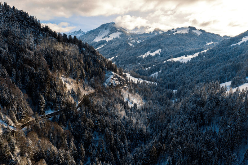Aerial view of road towards snowcapped mountain