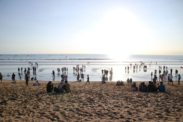 Panoramic view of people on beach against clear sky