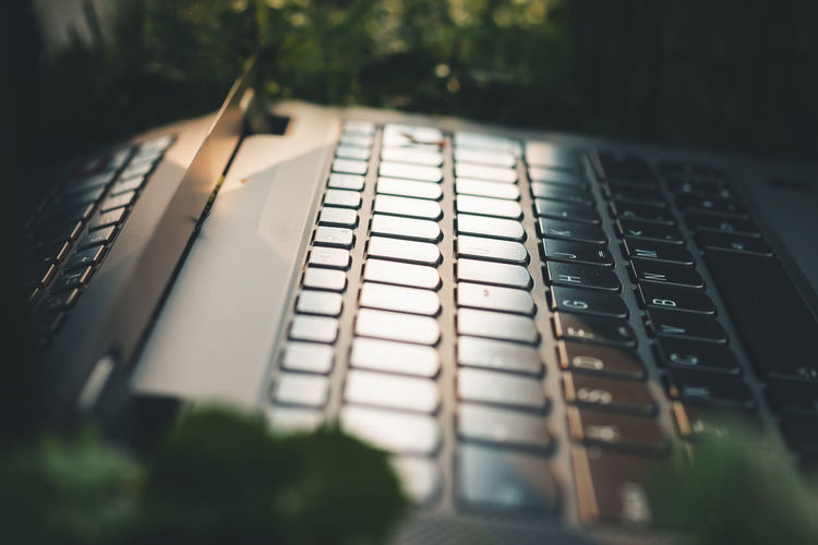 Close up shot of a laptop keyboard at golden hour outside